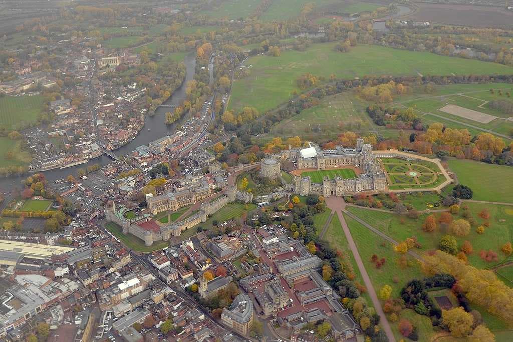 Aerial view of Windsor around its castle and Eton in the distance, with Home Park in the bottom right