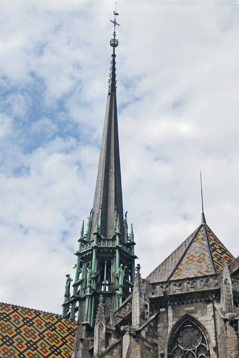 View of the spire of Dijon Cathedral, showing roofs with polychrome tiles.