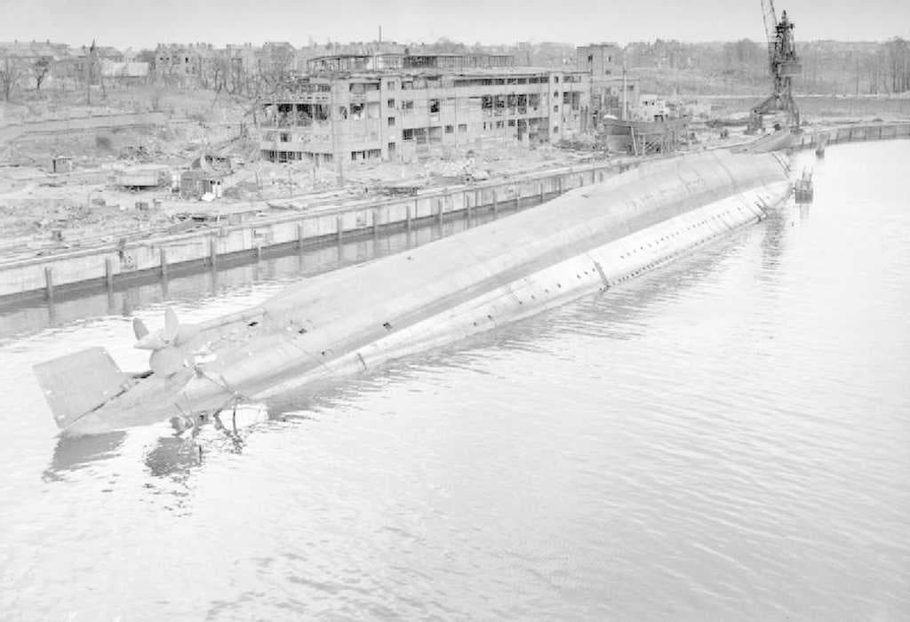 The German cruiser Admiral Scheer capsized in the docks at Kiel after being hit in an RAF raid on the night of 9/10 April 1945.