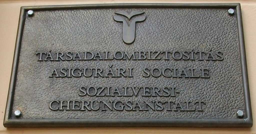 Trilingual (Hungarian, Romanian, German) table in Gyula (meaning "social health insurance")