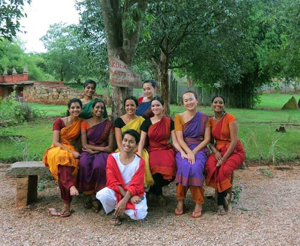 Classical dancers are relaxing at Nrityagram garden.