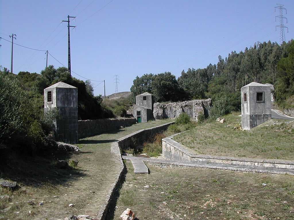 Part of the Roman Dam of Belas complex, showing the ventilation structures (foreground) and the remaining dam segment (background).