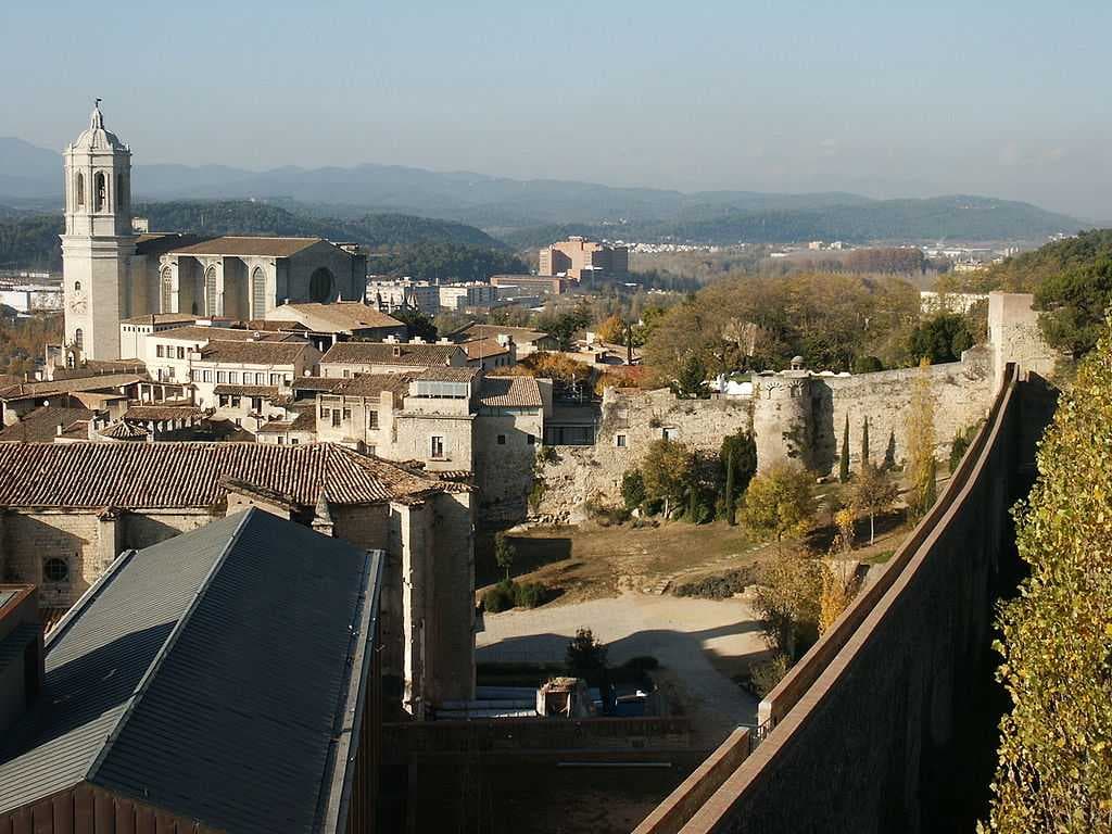 Girona landmarks include Saint Mary's Cathedral (left) and the City Walls Walkway (right).