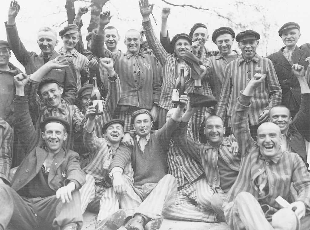 Polish prisoners in Dachau toast their liberation from the camp. Poles constituted the largest ethnic group in the camp during the war, followed by Russians, French, Yugoslavs, Jews, and Czechs.