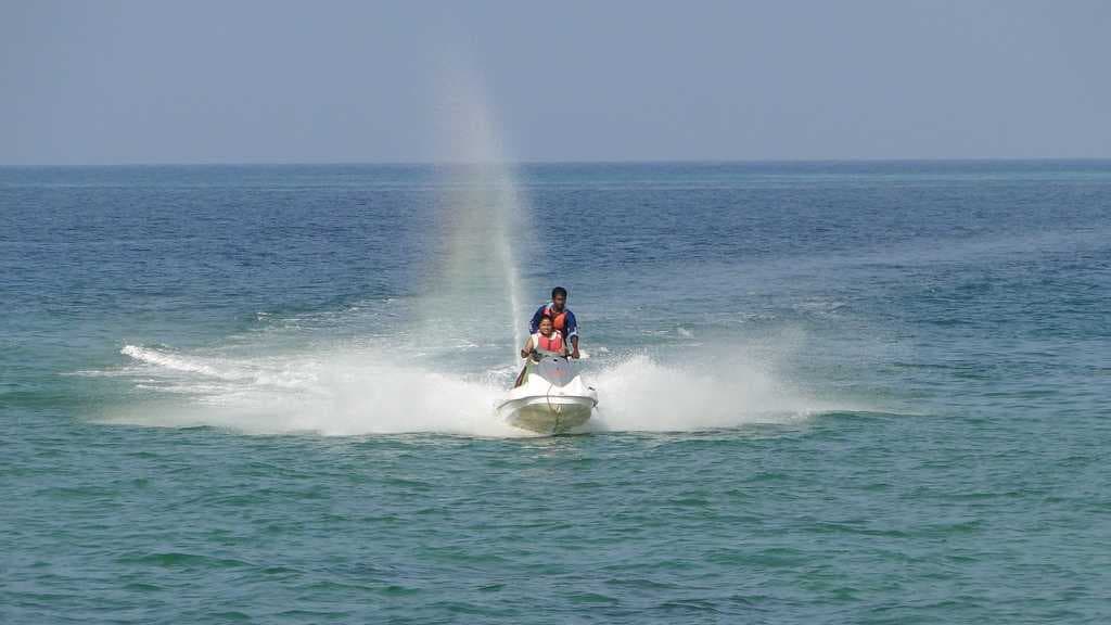 Tourists riding a water scooter off Port Blair, Andaman.