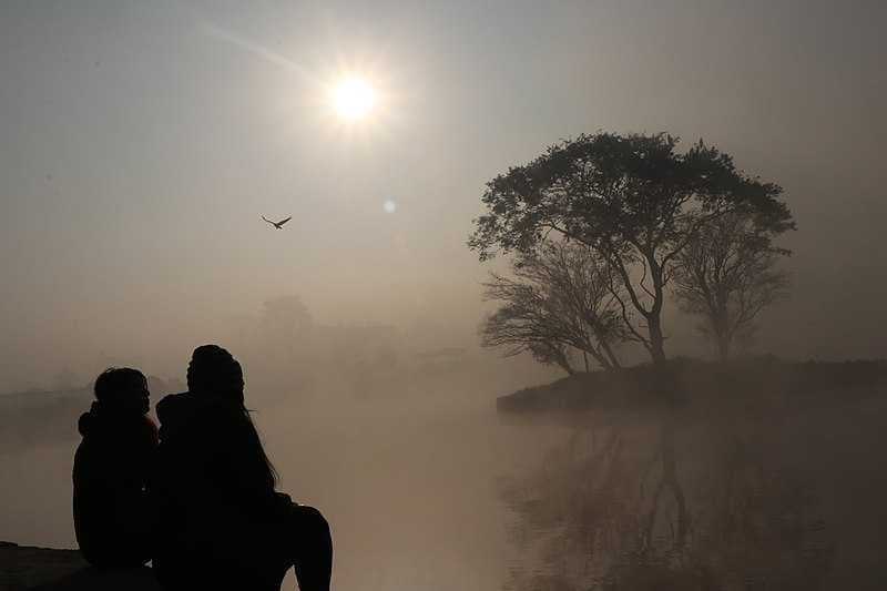 Friends watching sunrise at Taudaha Lake