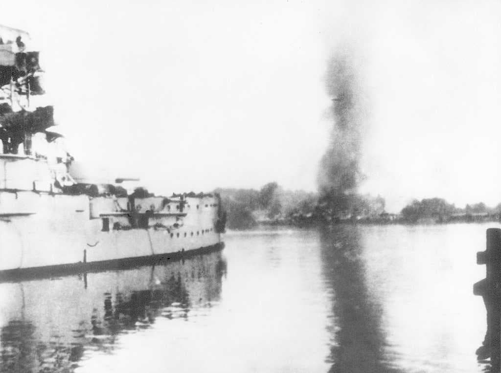 The German battleship SMS Schleswig-Holstein firing at the Polish Military Transit Depot during the battle of Westerplatte in September 1939
