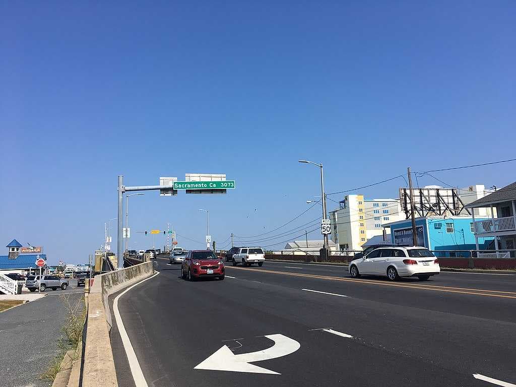 U.S. Route 50, also known as Ocean Gateway, leaving Ocean City; the sign over the eastbound lane displays the distance to the western terminus of route in Sacramento, California, as 3,073 miles.